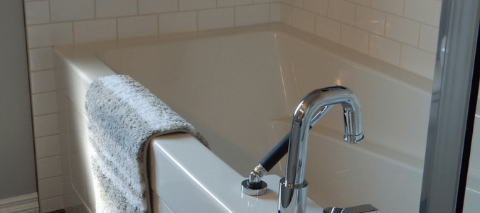 Grout or caulk around tub