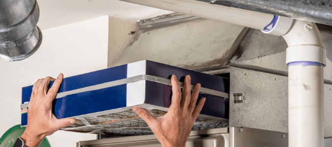 Person changing a furnace filter