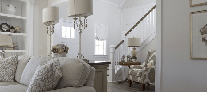 a white and gray living room and entryway