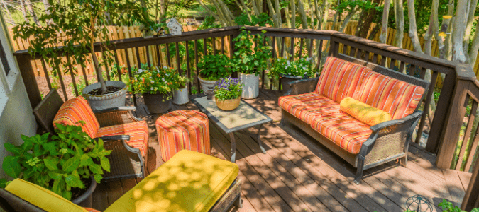 A deck with orange and yellow furniture