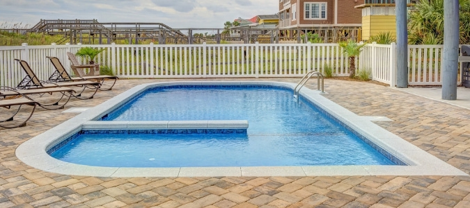 A swimming pool with brown tiles