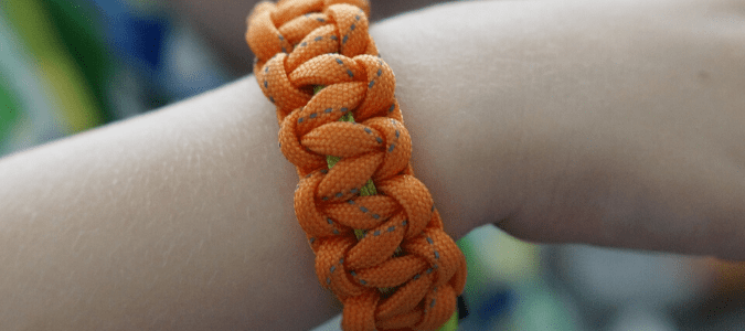 An orange mosquito repellent bracelet