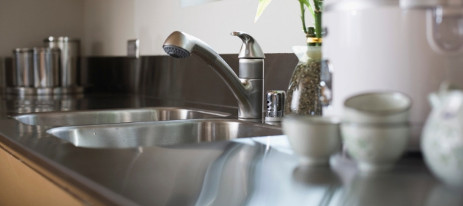 A stainless steel sink with a garbage disposal