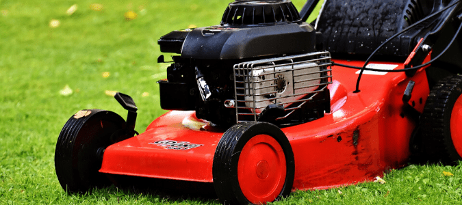 A homeowner mowing the lawn the correct height to help fix yellow spots in grass