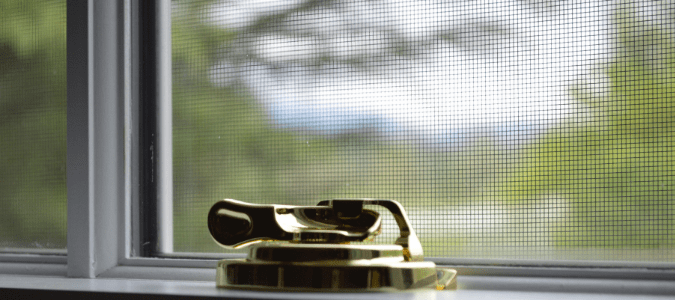 A window that has been firmly shut to prevent flies from coming inside