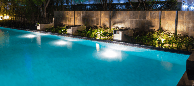 A yard where a homeowner has recently updated their landscape lighting around the pool