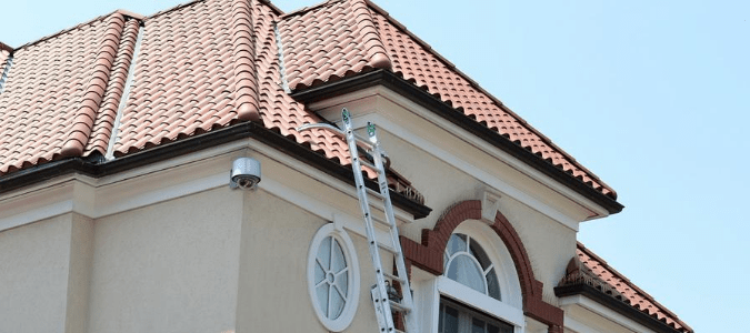 a ladder leaning against a house with no gutters