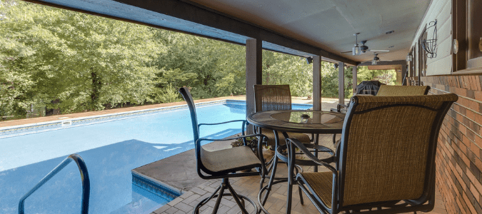 a deck next to a pool with lots of mosquitoes buzzing around