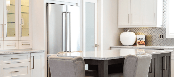 a stainless steel fridge in a white kitchen