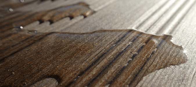 water on hardwood floor from a fridge leaking water